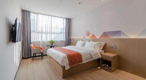 a hotel room with a bed and a window at Borrman Hotel Hefei Yaohai Wanda Linquan East Road in Hefei