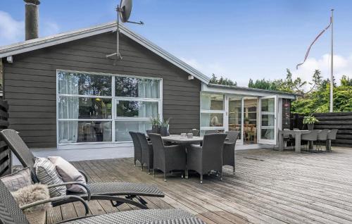 a patio with a table and chairs on a deck at Beautiful Home In Løgstrup in Løgstrup