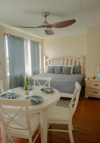 a bedroom with a bed and a table and chairs at West End Inn in West End