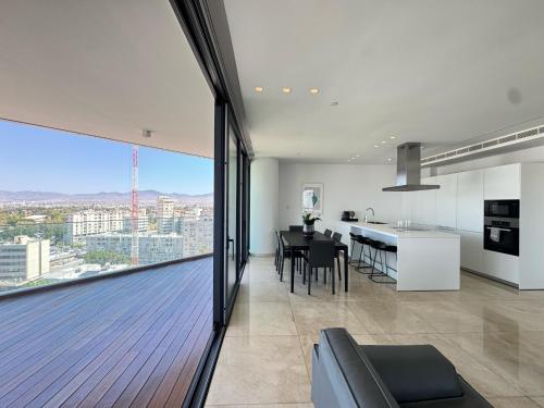 a large kitchen and dining room with a view of the city at SkyHigh Park View Living in Nicosia
