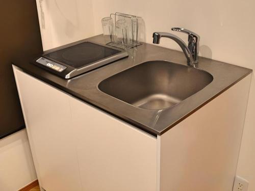 a sink in a kitchen with a counter top at HOSTEL LUND I -Oimachi- in Tokyo