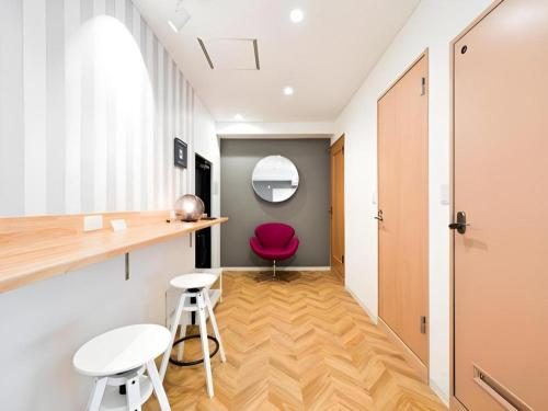 a room with a desk and a red chair at HOSTEL LUND I -Oimachi- in Tokyo