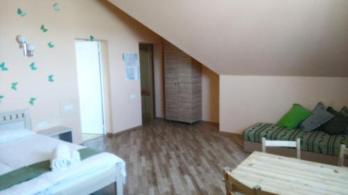 a bedroom with a bed and a couch in a room at Arsenal in Daugavpils