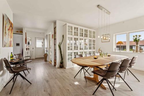 a kitchen and dining room with a table and chairs at Sea And Meadow Views Space And Calm in Nyborg