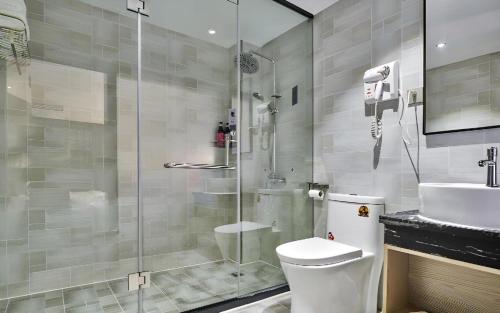 a bathroom with a shower and a toilet and a sink at Borrman Hotel Changsha Hunan Biological Electromechanical College in Changsha