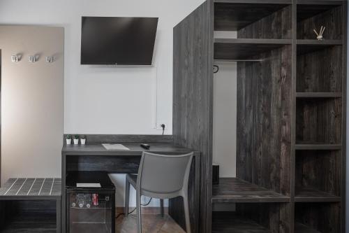 a room with a wooden desk and a chair at Urban Hotel in Cesena