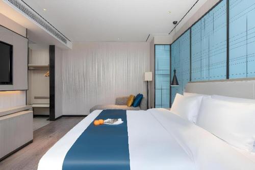 Ένα ή περισσότερα κρεβάτια σε δωμάτιο στο Echarm Hotel Zhuzhou Liling