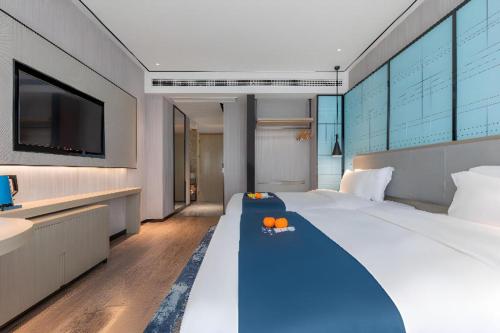 Ένα ή περισσότερα κρεβάτια σε δωμάτιο στο Echarm Hotel Zhuzhou Liling