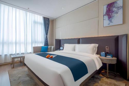 Ένα ή περισσότερα κρεβάτια σε δωμάτιο στο Echarm Hotel Zhuzhou Liling