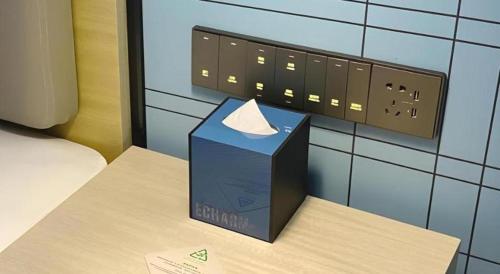 a box sitting on a table next to an electrical outlet at Echarm Hotel Shenzhen World Exhibition and Convention Center in Shenzhen