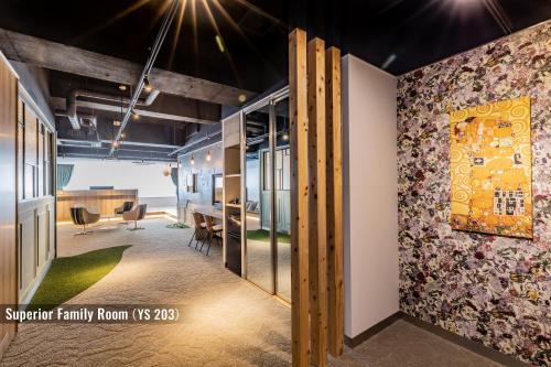 an office space with a wall mural of a family room at ビル泊 -Birupaku Decentralized Hotel- in Shizuoka