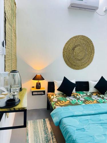 a bedroom with two beds and a table with a lamp at Coastal villa in Batticaloa