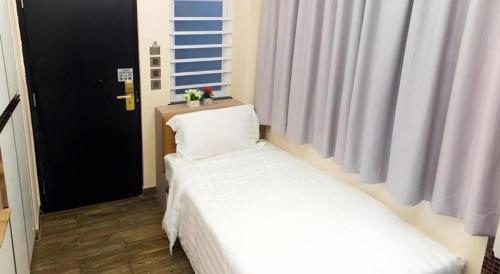 a bedroom with two beds and a window at Metroplace Boutique in Hong Kong
