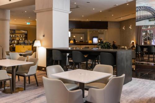 a restaurant with tables and chairs and a bar at Paradox Sydney in Sydney