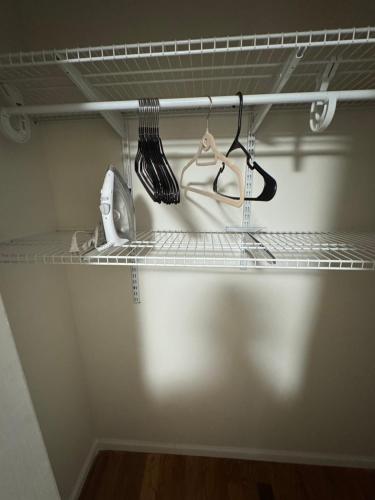 a shelf in a closet with someones clothes at Guiding Light in Springfield Gardens