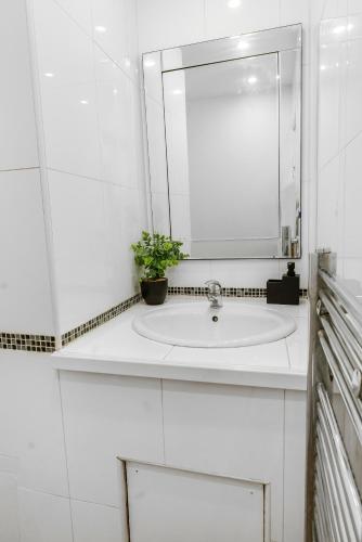 a white bathroom with a sink and a mirror at Unique 3 Bedrooms, 3 Ensuite, FREE WiFi, Private Parking in Tottington