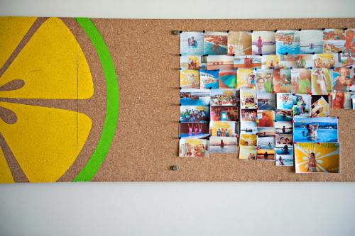 a cork bulletin board with many photos on it at Lime Hotel Boracay in Boracay