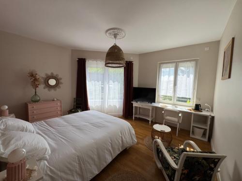 a bedroom with a white bed and a desk at Le Clos Les Brunes in Limoges