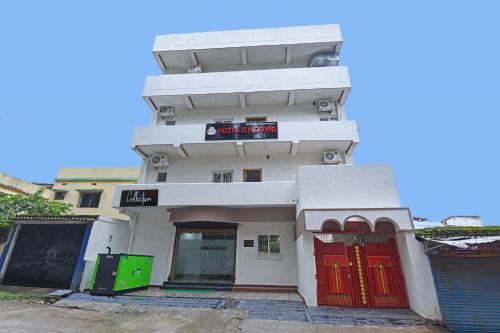 a white building with red doors in front at Collection O D N Grand in Rānchī