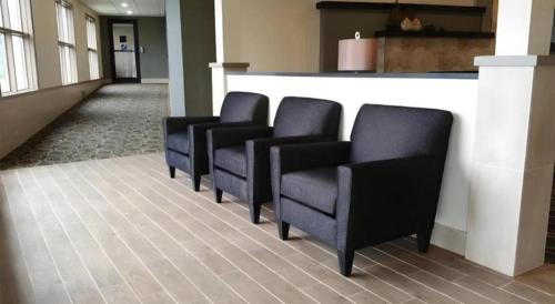 a row of black chairs in a waiting room at Quality Inn in Geneseo