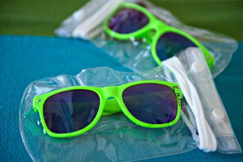 a pair of green sunglasses sitting on a table at Lime Hotel Boracay in Boracay