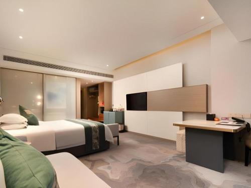 Zhangjiagang Guomao Hotelにあるテレビまたはエンターテインメントセンター