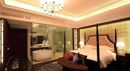 a bedroom with a bed and a tub and a chair at Eden Club House in Tongxiang