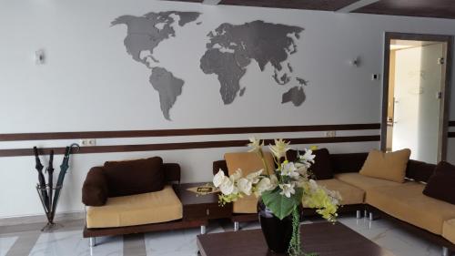 a living room with a map of the world on the wall at Palma Palace Hotel in Yerevan