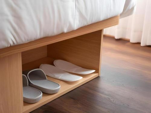 a bunk bed with two stools under a bed at Harbour Bay Hotel in Hong Kong
