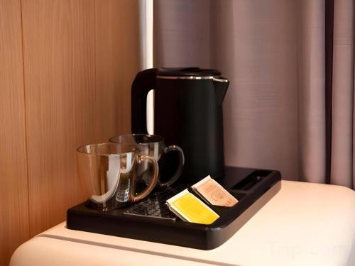 a coffee maker on a tray on a table at Harbour Bay Hotel in Hong Kong