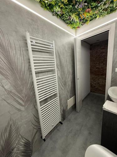 a bathroom with a wall with plants on it at City Garden in Rovigo