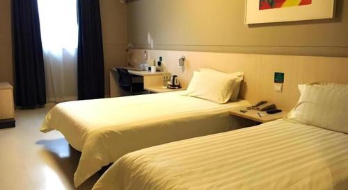 a hotel room with two beds and a telephone at Jinjiang Inn Nanjing Xinjiekou in Nanjing