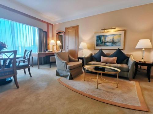 a living room with a couch and a table at Regency Hotel in Shantou