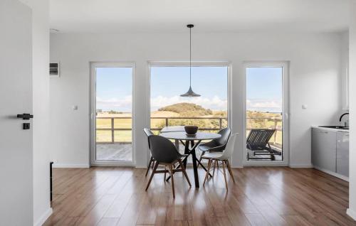 a kitchen and dining room with a table and chairs at 1 Bedroom Stunning Home In Sejerø in Sejerby
