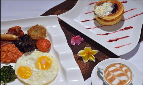 a plate of breakfast food with eggs and a muffin at The Trawangan Resort in Gili Trawangan