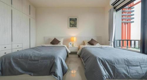 Un pat sau paturi într-o cameră la At One Hotel Chiangrai