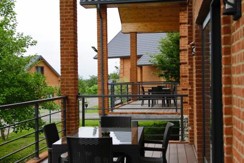 a patio with tables and chairs on a balcony at Dad Residence in Lankaran