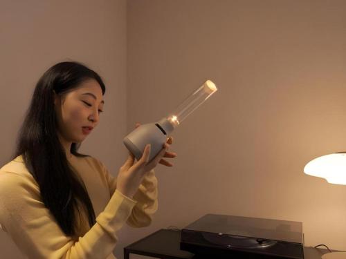 a woman holding a blow dryer in a room at CS Premier Hotel in Seoul