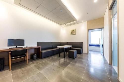 an office with a couch and a table and a desk at CS Premier Hotel in Seoul