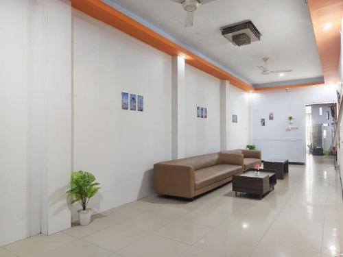 a living room with a couch and a table at YUTAKA INN Nabila Juanda Airport Sidoarjo in Semampir
