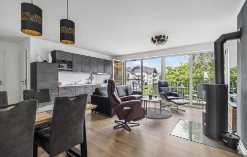 a kitchen and living room with chairs and a table at Gebirgsresort Winterberg in Winterberg