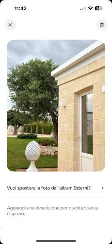 a white vase sitting in front of a building at Santo Stefano in Monopoli