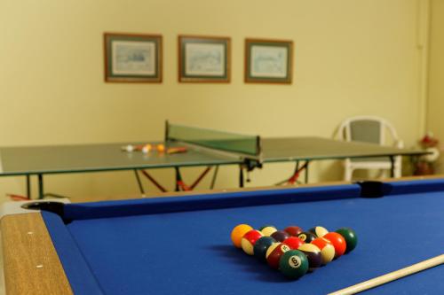 a pool table with balls on top of it at Indigo Mare in Plataniás