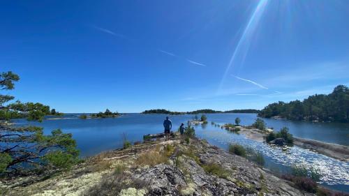 a man standing on the edge of a lake at Villa Sjöbris - Lake Vänern in Ängenäs