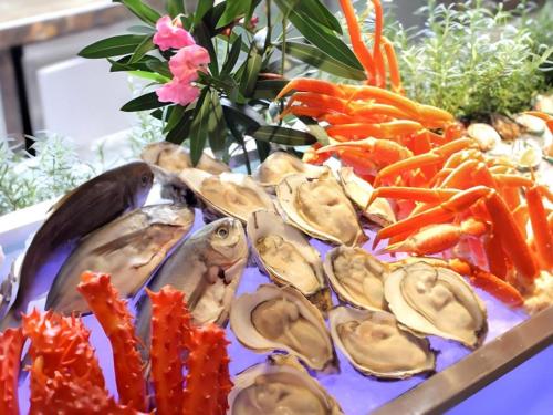 a plate of oysters and carrots on a table at Kunshan Newport Hotel in Suzhou