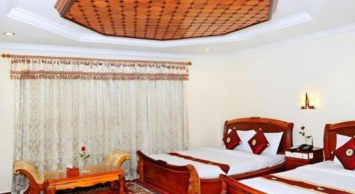 Кровать или кровати в номере Vy Chhe Hotel