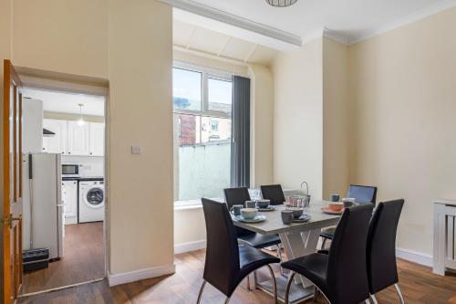 a dining room with a table and chairs at Relax in Comfort 3BR Home for 6 with Full Kitchen, Lounge, Large Bath in Bury