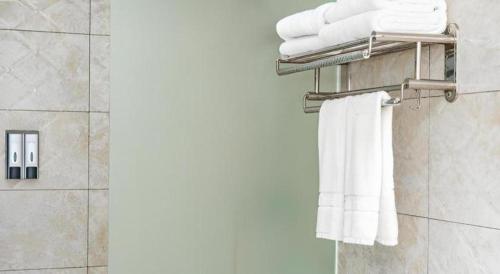a bathroom with white towels on a towel rack at Jian Guo Grand Hotel in Vientiane