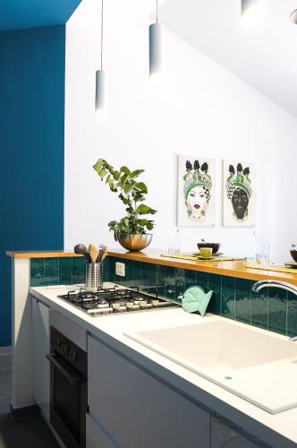 a kitchen with a white counter top and a sink at Villa Bruca 2 appartamenti al mare in Caronia Marina