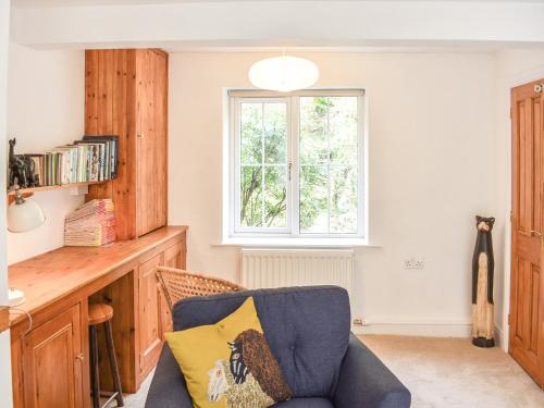 a living room with a couch and a window at Riverside Cottage in Keswick